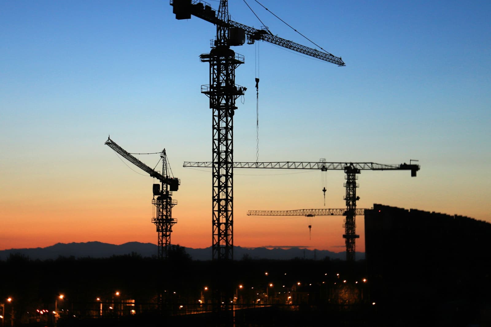 Tower crane silhouetted at sunset